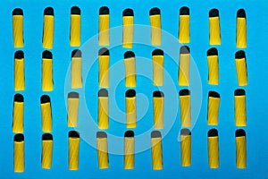 Macaroni is arranged in rows on a blue background