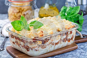 Macaroni casserole with ground beef, cheese and tomato in glass baking dish, horizontal
