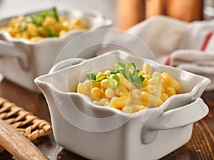 Macaroni and cheese in dish with scallions