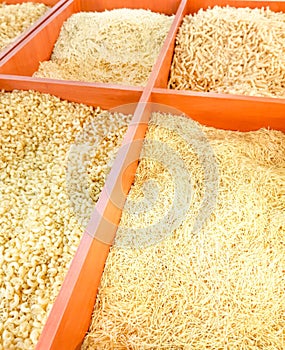 Macaroni, pasta in boxes on the counter in the supermarket. food background