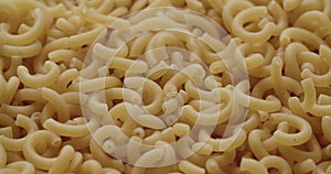 Macaroni Pieces Being Added To Heap Of Dried Pasta