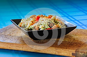 Macaroni salad in a square bowl