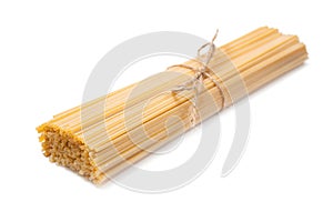 Macaroni unprepared raw rope tied spaghetti from durum wheat handmade isolated on white