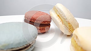 Macarons from natural ingredients and dyes on white table.