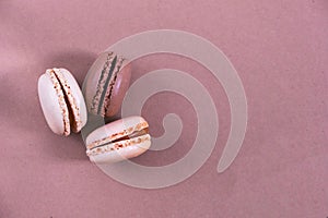 Macarons on a paper background, brown and beige background