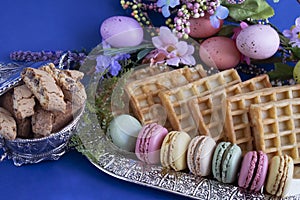 Macarons and various sweet treats photographed with easter decor