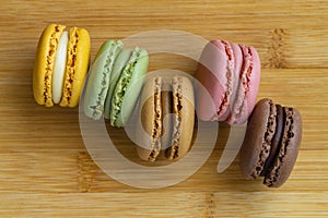 Macarons. Very colorful French typical cakes on wooden board. photo