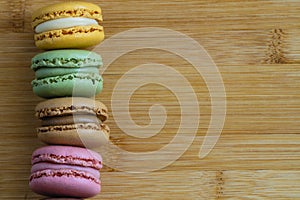 Macarons. Very colorful French typical cakes on wooden board. photo