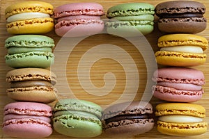 Macarons. Very colorful French typical cakes on wooden board. photo