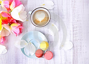 Macaroon and cofee on wooden table top view.