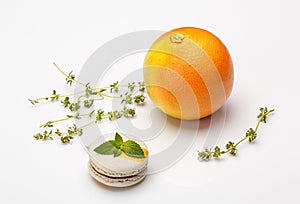 Macaroon cookies with mint and orange flavor on a white background