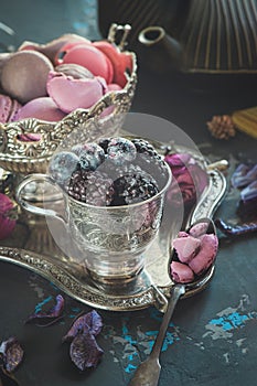 Macaroons with blackberries and blueberries. Still life with berries and almond cookies