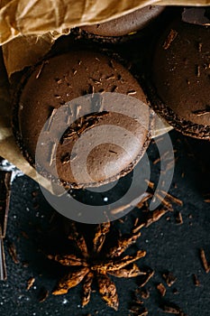 Macaroons with chocolate and badiane on a black background