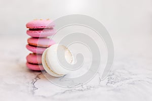Macaroons close up. Pink and white macaroons on the murble table