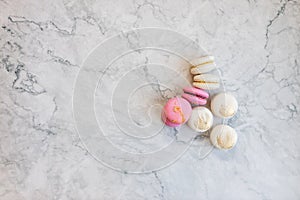 Macaroons close up. Pink and white macaroons on the murble table