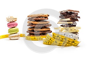 Macaroons, cookies, chocolate bars and measuring tape