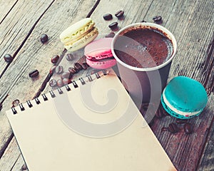 Macaroons cookies, espresso coffee cup and sketch book