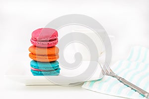 Macaroons on white plate and coffee cup