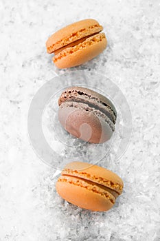 Macaroons on white snow background top, colorful macaroons, selective focus