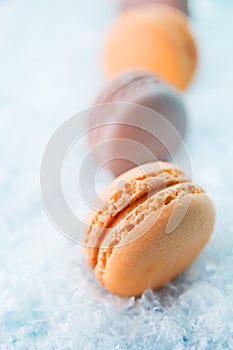 Macaroons on white snow background top, colorful macaroons, selective focus