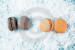 Macaroons on white snow background top, colorful macaroons, selective focus