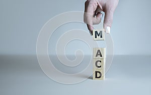 MACD - Moving Average Convergence Divergence acronym, business concept on wooden cubes photo