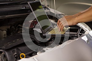 Machanic Man Maintenance a car engine at repair shop