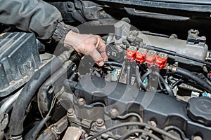 Machanic repairman at the LPG converted engine. Disassembled motor vehicle