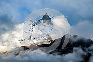 Machapuchare, Fish Tail Mountain rising above the clouds from the Annapurna base camp trail, Nepal