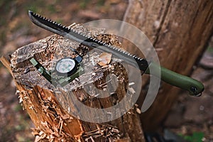 Machete with compass in forest.Selective focus
