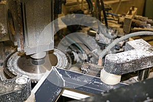 A machine adjusts a PVC window frame in a carpentry