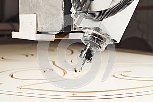 Machine with computer numerical control for cutting wood with various router bits.