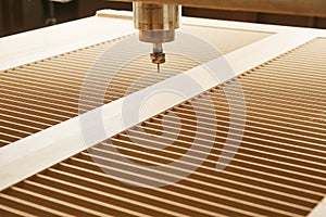 Machine with computer numerical control for cutting wood with various router bits.