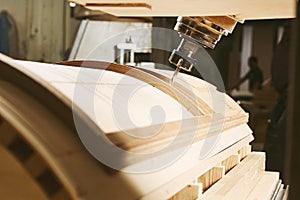 Machine with computer numerical control for cutting wood with various router bits.