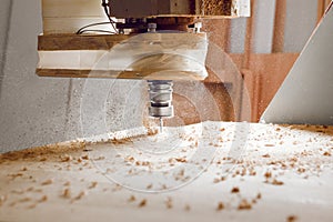 Machine with computer numerical control for cutting wood with various router bits.