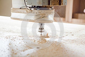 Machine with computer numerical control for cutting wood with various router bits.