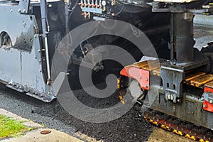 The machine is cutting asphalt, cutting old asphalt with a special machine and loading it into a dumper