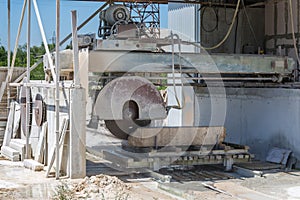 Machine cutting a granite block.