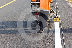 Machine eject and worker on road.