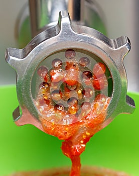 Machine is grinding up tomatoes