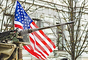 Machine gun mounted on United States Marine Corps forces tank or military vehicle with American flag