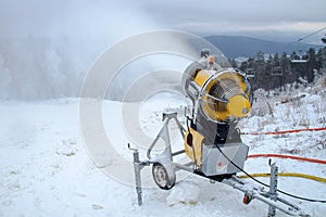 Machine gun for the production of artificial snow in the winter mountains, prepare for ski activities