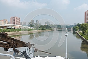 Machine gun on the ship Pueblo in background Pyongyang