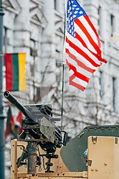 Machine gun on a tank or military vehicle with American and Lithuanian flag