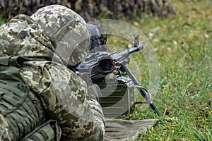 Machine gunner operator in camouflage uniform