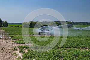 Machine irrigation of an agricultural field with water.