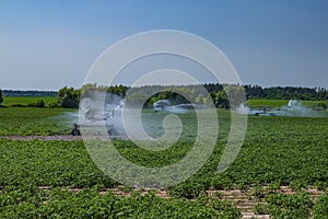 Machine irrigation of an agricultural field with water.