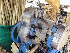 Machine for make sugarcane juice with sugar cane background from