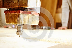 Machine with numerical control cuts wood. CNC device in the carpentry shop.