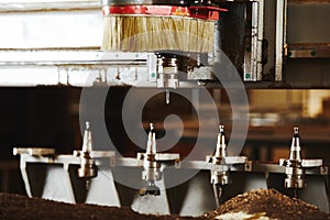 Machine with numerical control for cutting wood with various router bits.